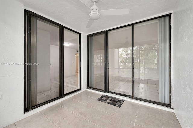 doorway to property featuring ceiling fan and a patio area