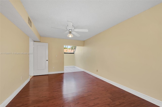 empty room with ceiling fan, a textured ceiling, and hardwood / wood-style flooring