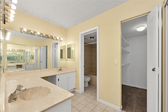 full bathroom featuring toilet, tiled shower / bath, tile patterned floors, a textured ceiling, and vanity