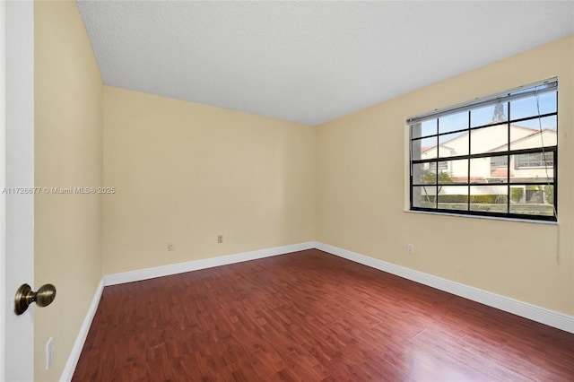 spare room featuring wood-type flooring