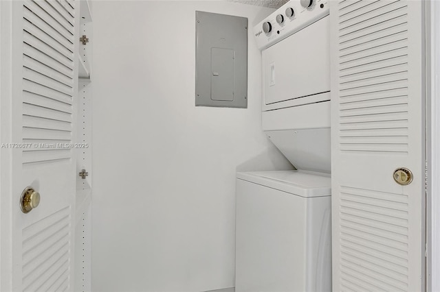 washroom featuring stacked washer and dryer and electric panel