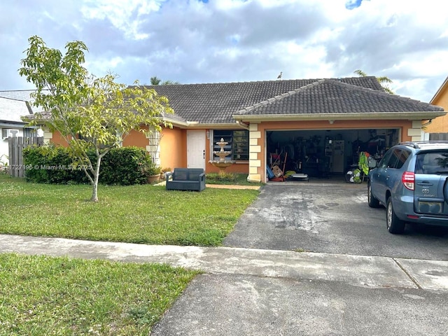 ranch-style home featuring a garage and a front yard