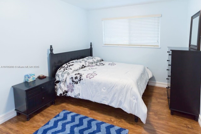 bedroom with hardwood / wood-style floors