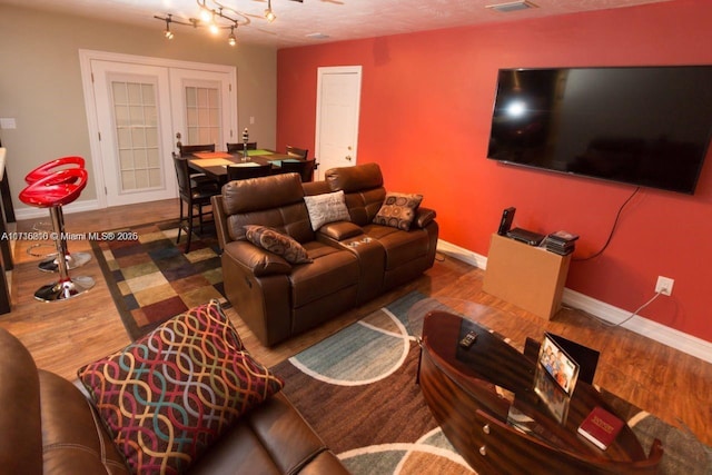 living room featuring french doors and wood-type flooring