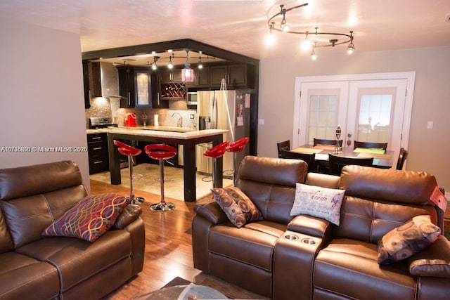 living room featuring sink and light hardwood / wood-style flooring