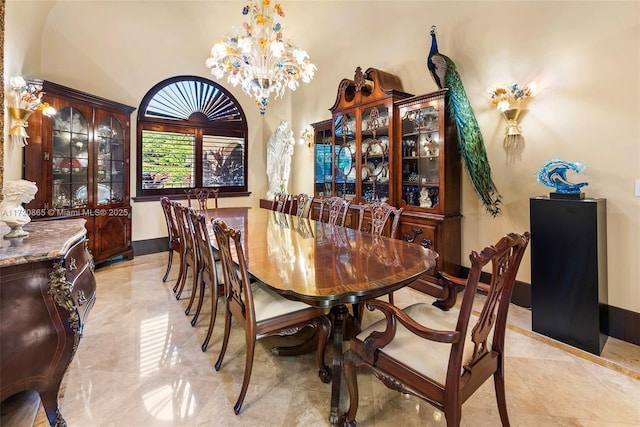 dining area featuring a high ceiling and a notable chandelier