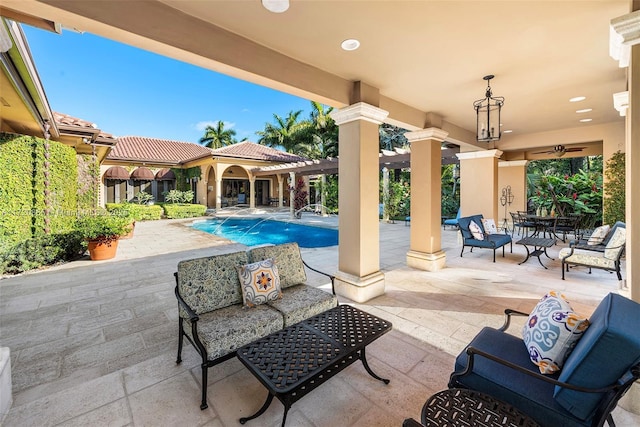 view of patio / terrace featuring pool water feature and outdoor lounge area