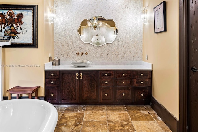 bathroom featuring vanity and a washtub