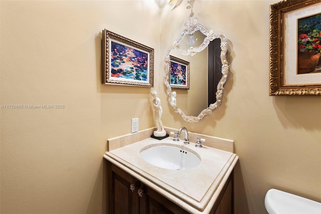 bathroom with toilet and vanity