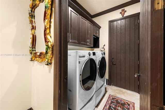 clothes washing area with washing machine and dryer, cabinets, ornamental molding, and light tile patterned floors