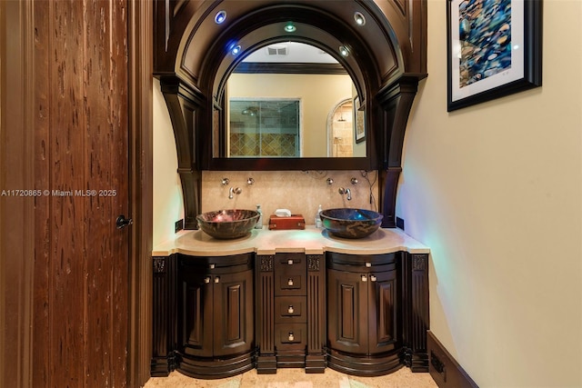 bathroom featuring tasteful backsplash, vanity, and ornamental molding