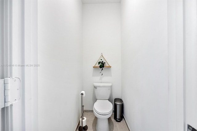 bathroom featuring toilet and tile patterned floors