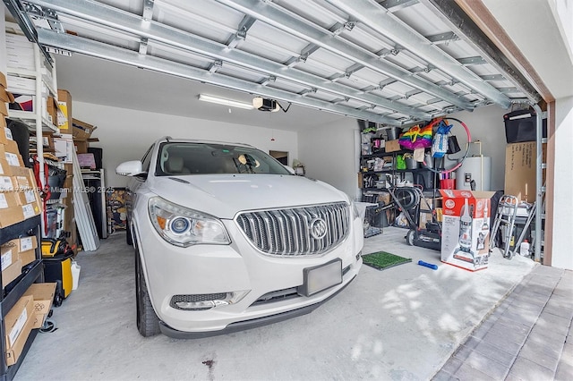 garage featuring a garage door opener and water heater