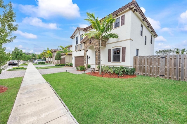 mediterranean / spanish-style home with a garage and a front yard