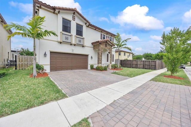 mediterranean / spanish-style house with a front yard and a garage