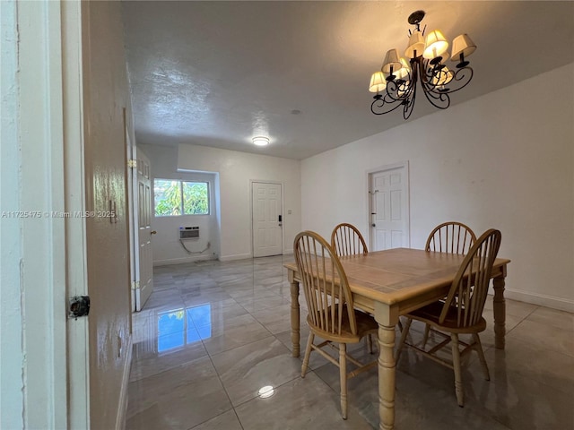 dining space featuring an AC wall unit and a chandelier