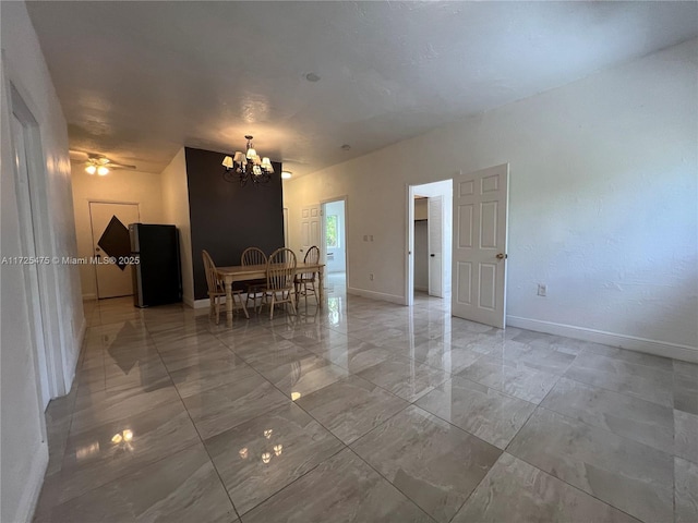 dining area with marble finish floor, baseboards, and an inviting chandelier