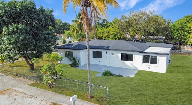 back of property featuring a yard and a patio