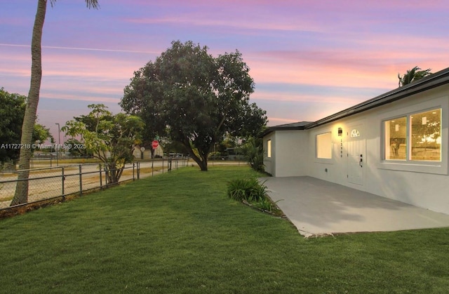 yard at dusk with a patio