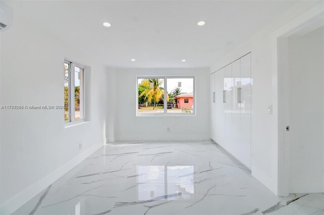 kitchen featuring tasteful backsplash, stainless steel appliances, white cabinetry, and a center island