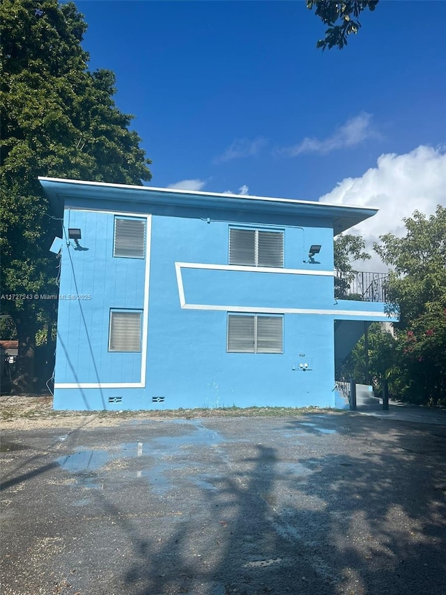 view of home's exterior with a balcony