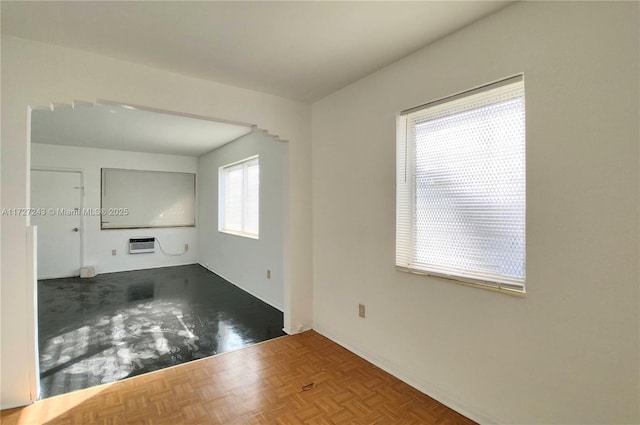 spare room with parquet floors and a wall mounted AC