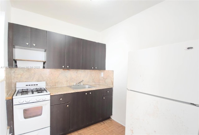 kitchen featuring sink, white appliances, dark brown cabinetry, and light parquet flooring