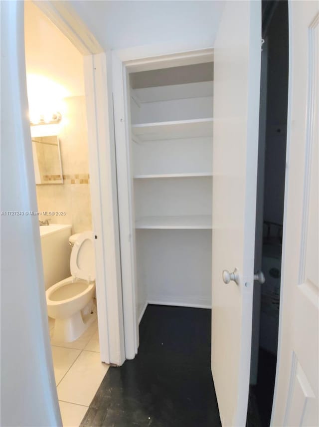 interior space with toilet and tile patterned floors