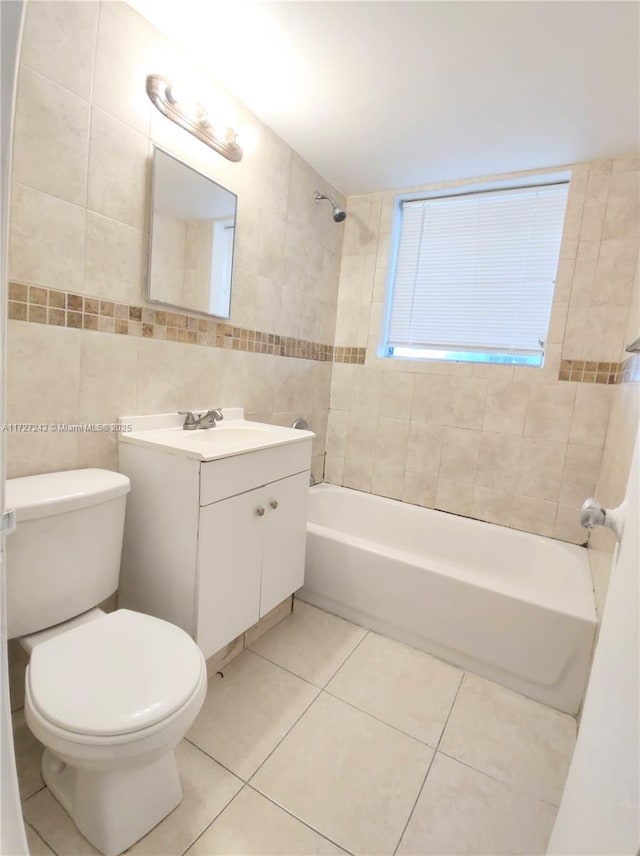 full bathroom featuring toilet, tile walls, tile patterned flooring, and vanity