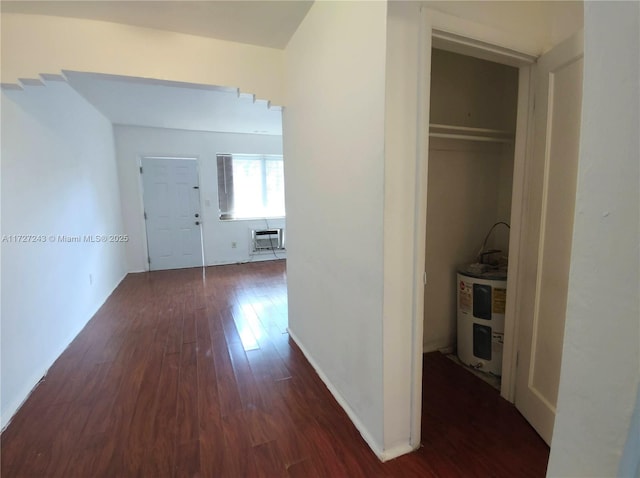 hallway featuring a wall mounted AC, water heater, and dark hardwood / wood-style floors