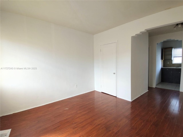 unfurnished bedroom featuring dark hardwood / wood-style floors