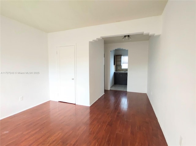 spare room with dark hardwood / wood-style floors