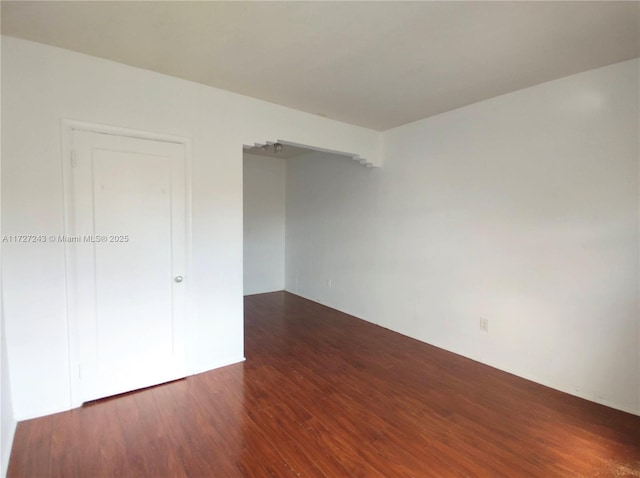 spare room featuring dark hardwood / wood-style floors