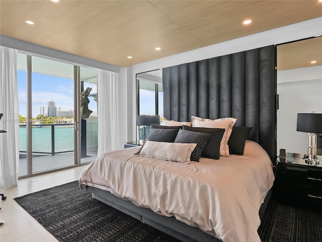 tiled bedroom featuring access to outside and a water view