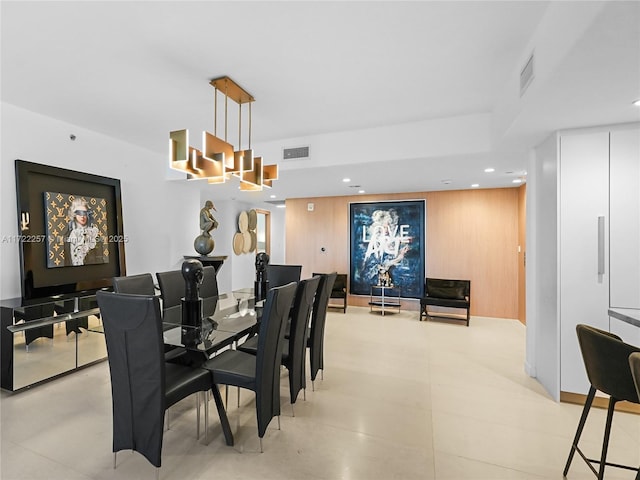 dining room with wood walls