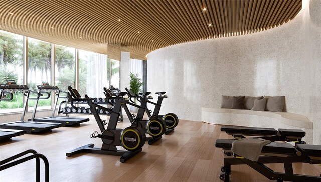 1135 103rd St Unit 502, Bay Harbor Islands, FL 33154 - workout area featuring plenty of natural light, wood finished floors, and floor to ceiling windows