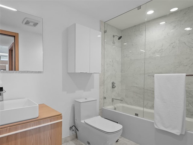 full bathroom with toilet, tiled shower / bath combo, and vanity