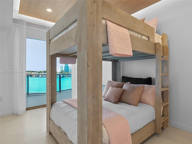 bedroom featuring wooden ceiling, a water view, and access to outside