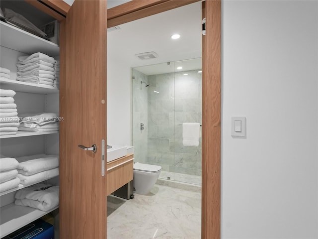 bathroom with toilet, a shower with door, and vanity