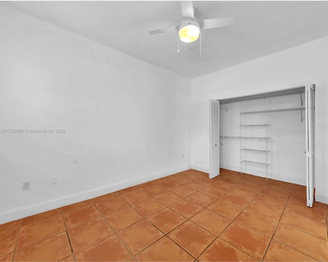 unfurnished bedroom featuring tile patterned floors, baseboards, a closet, and ceiling fan