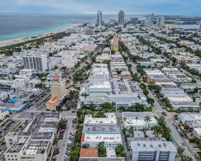 birds eye view of property with a water view and a view of city