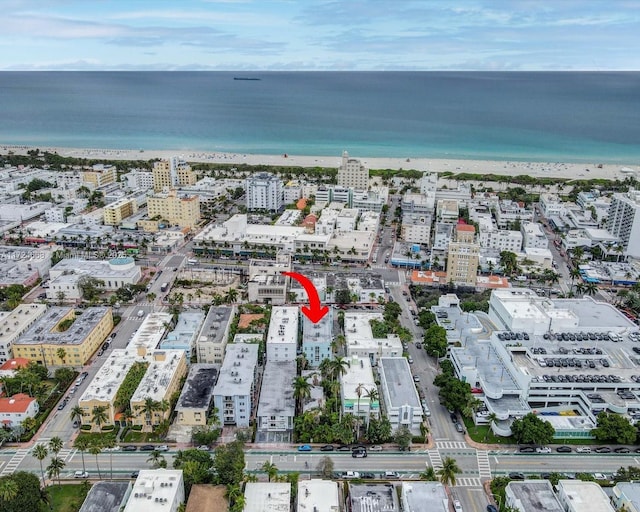 aerial view featuring a view of the beach, a water view, and a view of city
