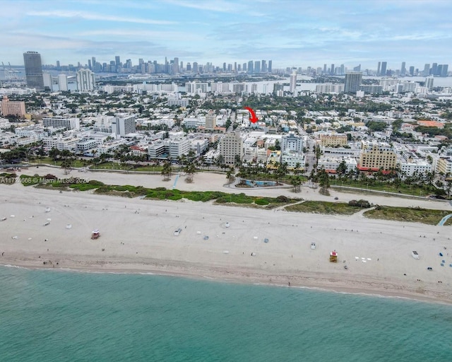 bird's eye view featuring a view of city, a beach view, and a water view