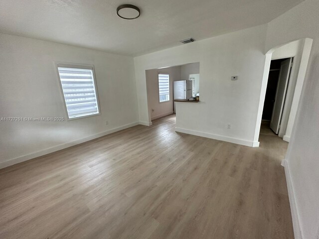 spare room with light wood-type flooring