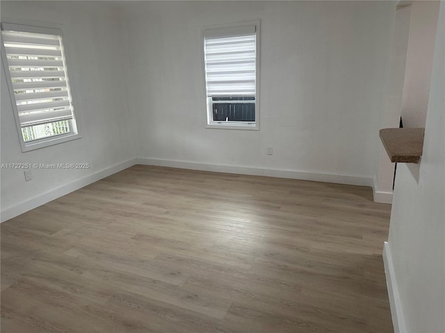 unfurnished room featuring light hardwood / wood-style floors