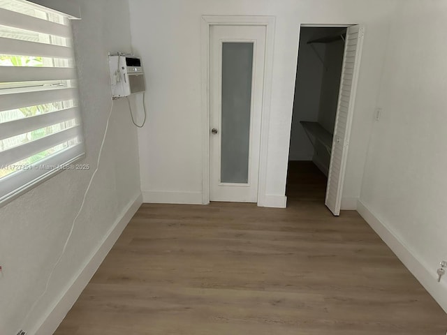 unfurnished bedroom with hardwood / wood-style floors