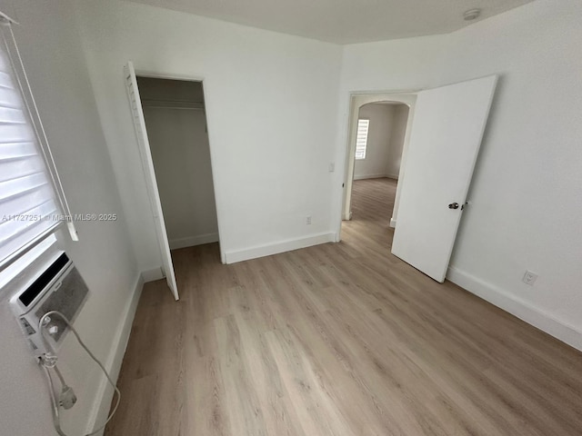 unfurnished bedroom featuring light hardwood / wood-style floors and a closet