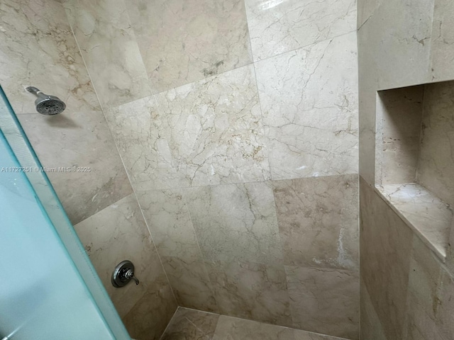 bathroom with tiled shower