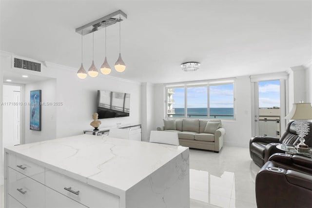 kitchen featuring white cabinets, a kitchen island, and pendant lighting