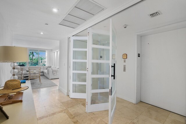 corridor with light tile patterned floors and elevator